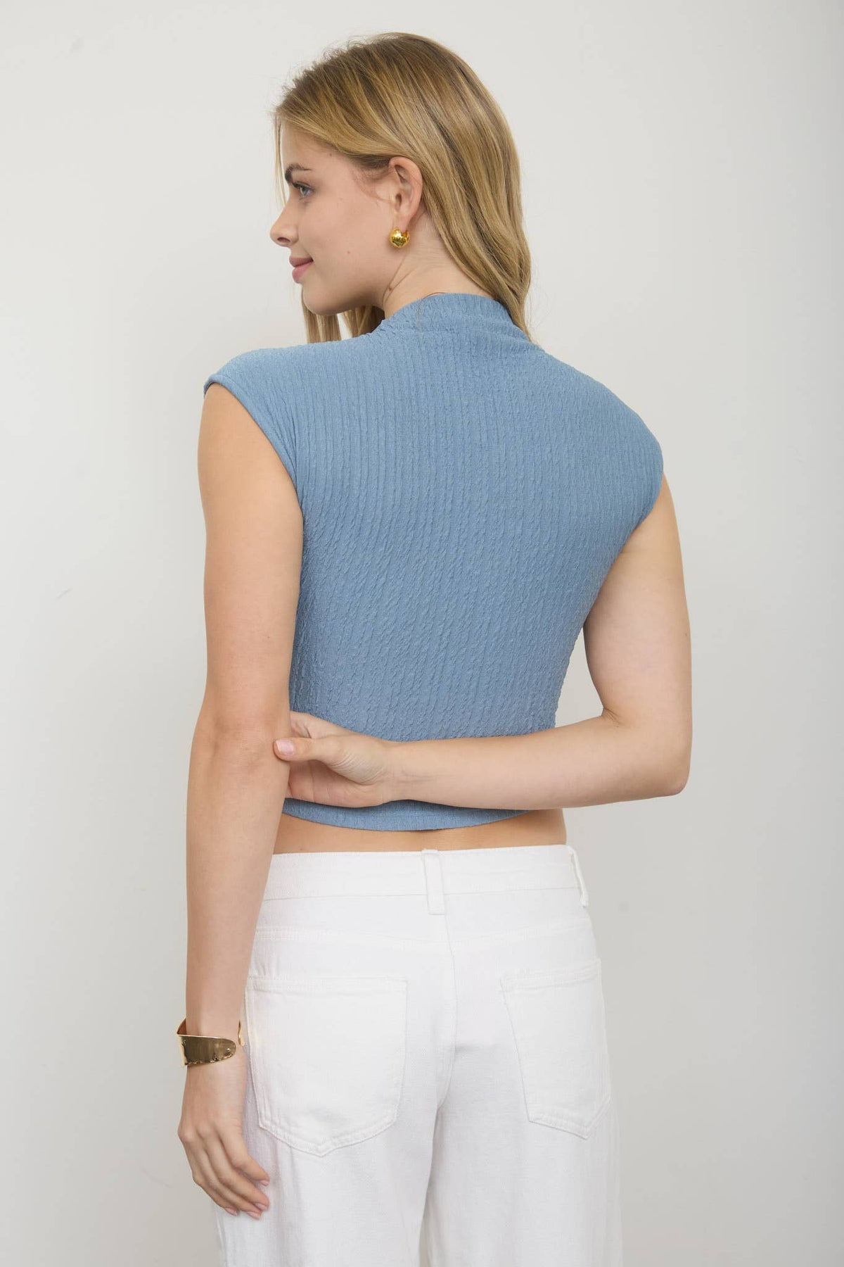 ASYMMETRICAL HEM MOCK NECK SLEEVELESS KNIT TOP