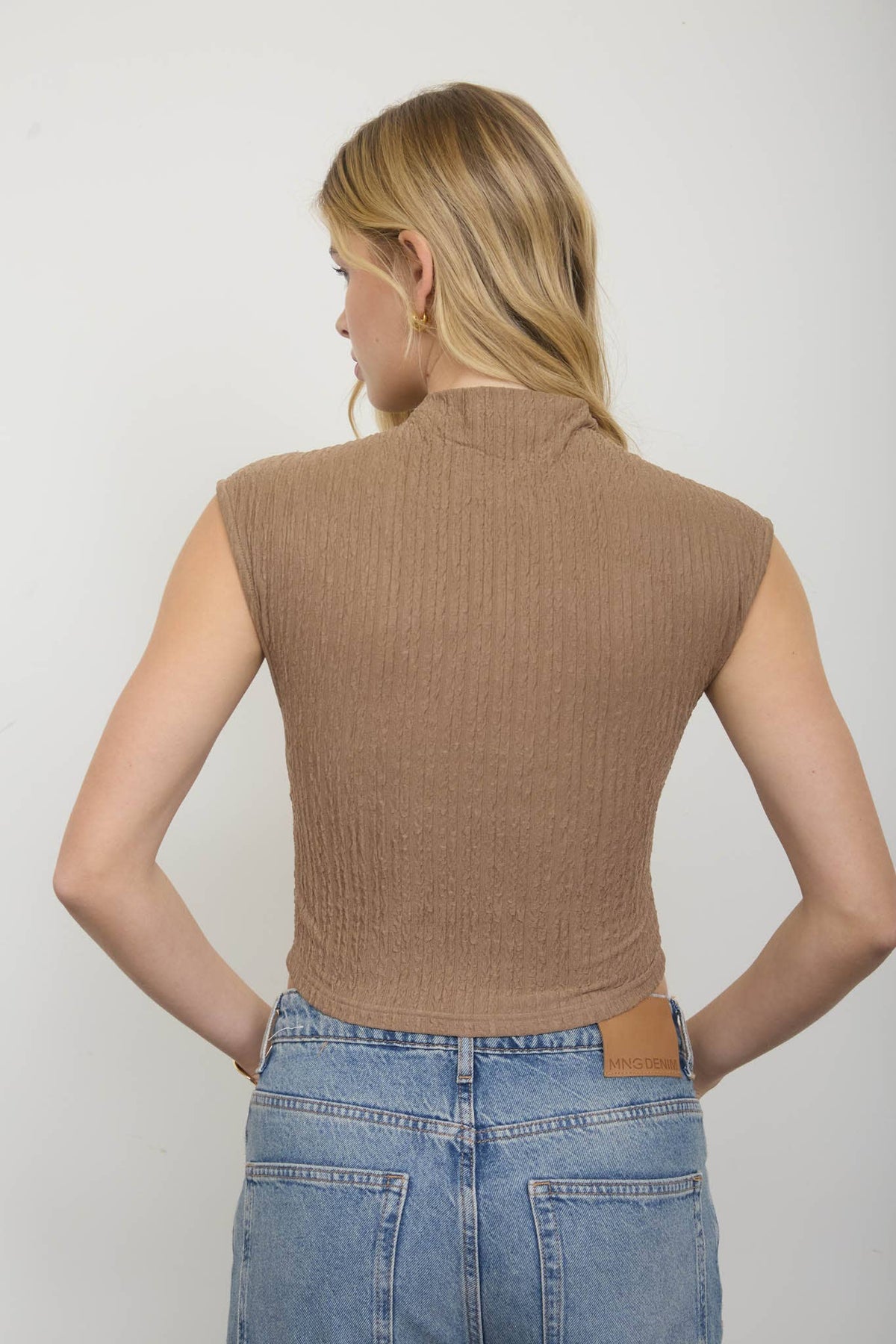 ASYMMETRICAL HEM MOCK NECK SLEEVELESS KNIT TOP